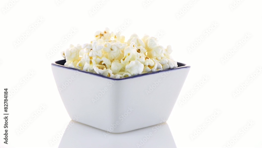 Popcorn in a white bowl on a white background Popcorn in a white bowl on a white background