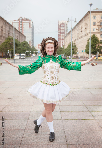 Young woman in irish dance dress and wig posing photo