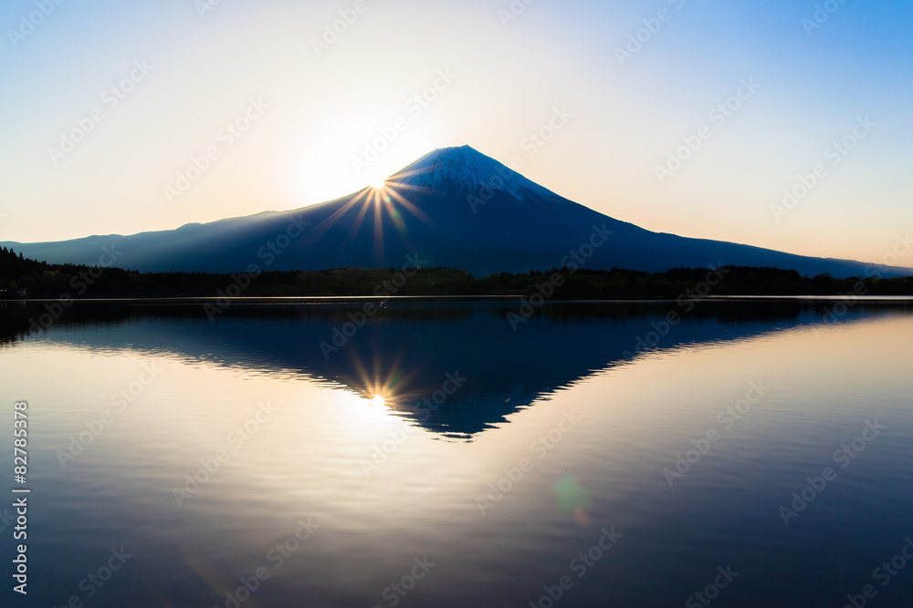 Silhouette of Mount Fuji reflected in Lake Tanukiko 
