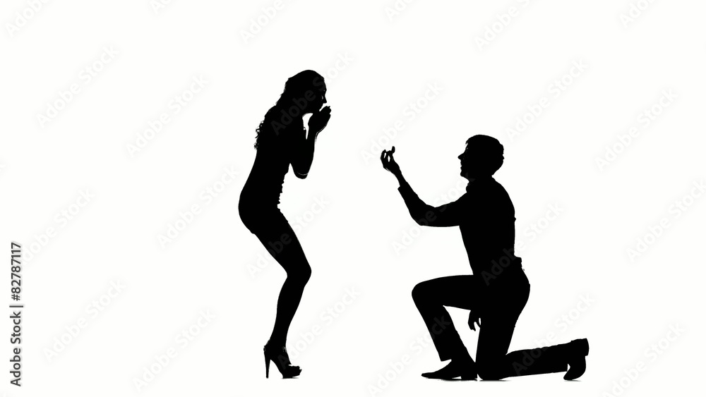 Silhouette of man on one knee and kissing womans hand. Stock Video