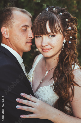 wedding couple kissing in green summer park. bride and groom