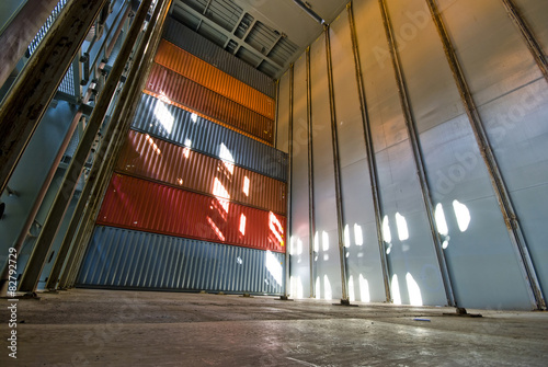 Stacked cargo containers in ship's cargo hold photo