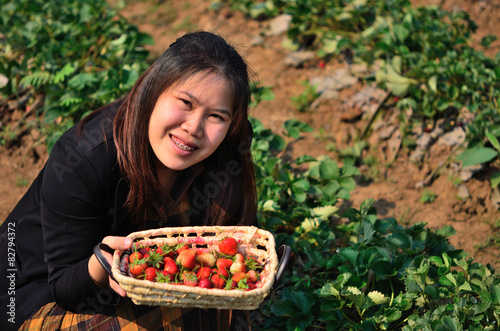 The basket of strawberries in the hand