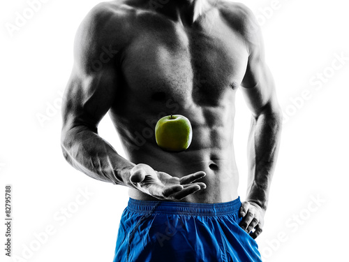 Fototapeta man exercising fitness exercises eating apple  silhouette