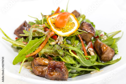 duck with arugula on a white background in the restaurant