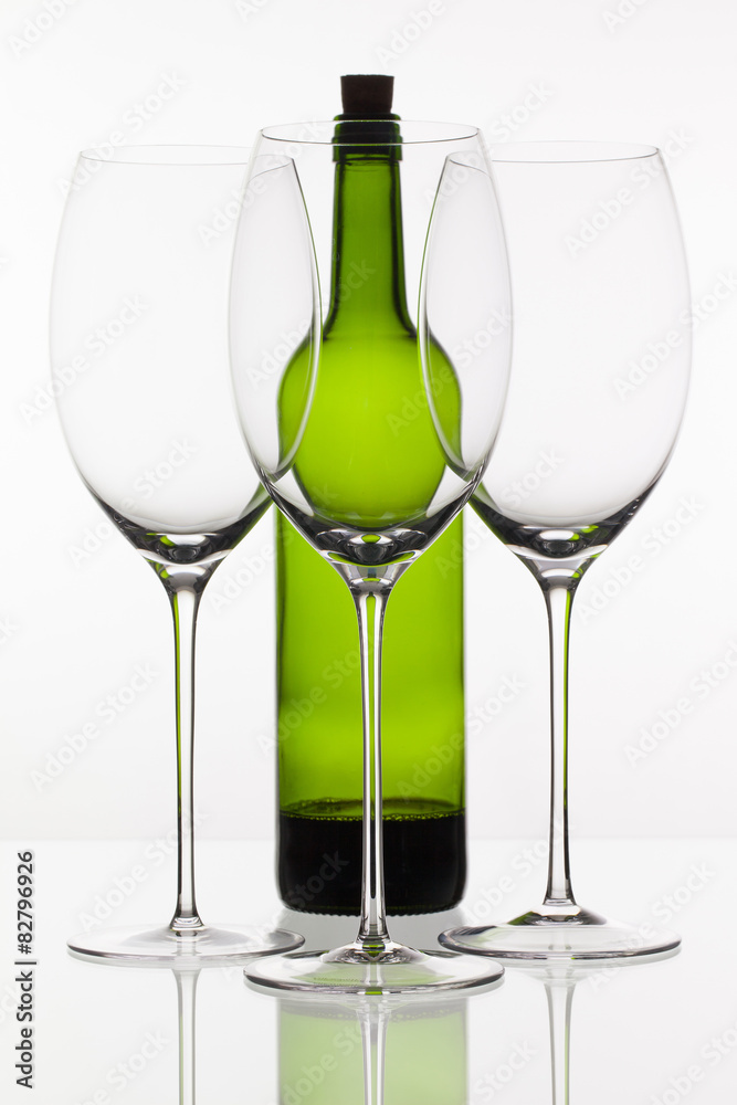 Three empty glasses of wine and green bottle Three empty glasses of wine and green bottle