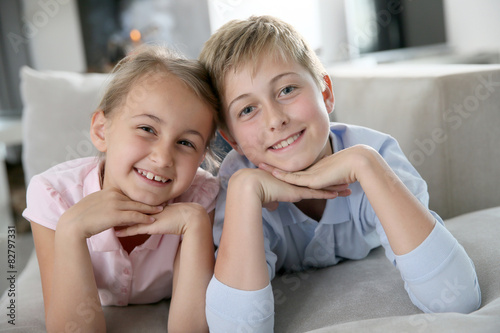 Portrait of kids laying in sofa at home
