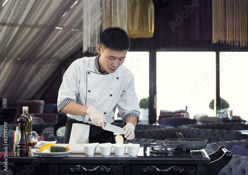 Japanese chef preparing a meal in a restaurant