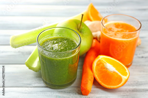 Assortment of healthy fresh juices on wooden table background