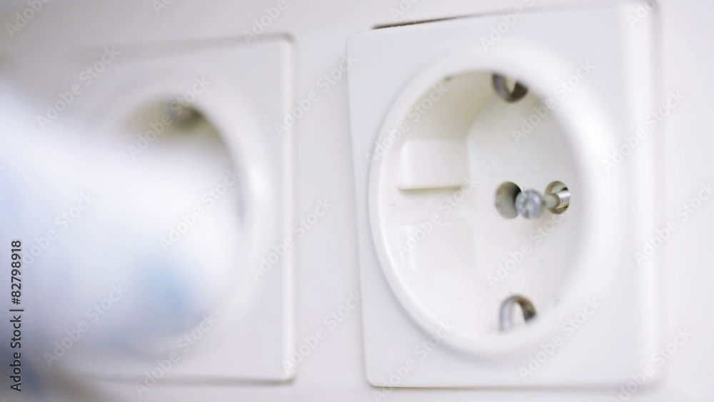 close up of hand with screwdriver fixing socket