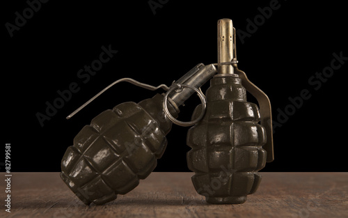 two hand grenade on wooden table