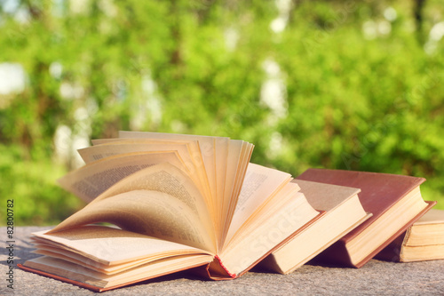 Stack of books outdoors, on blurred background