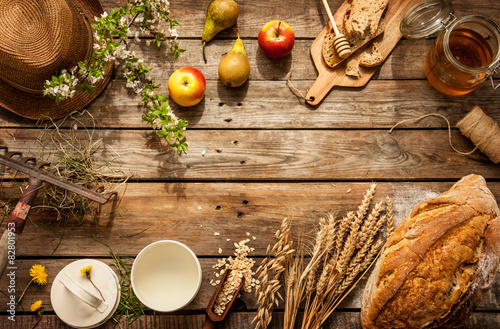 Natural local food products on vintage wooden table - rustic composition captured from above. Country lifestyle, rural vacation or agritourism concept. Background layout with free text space. photo