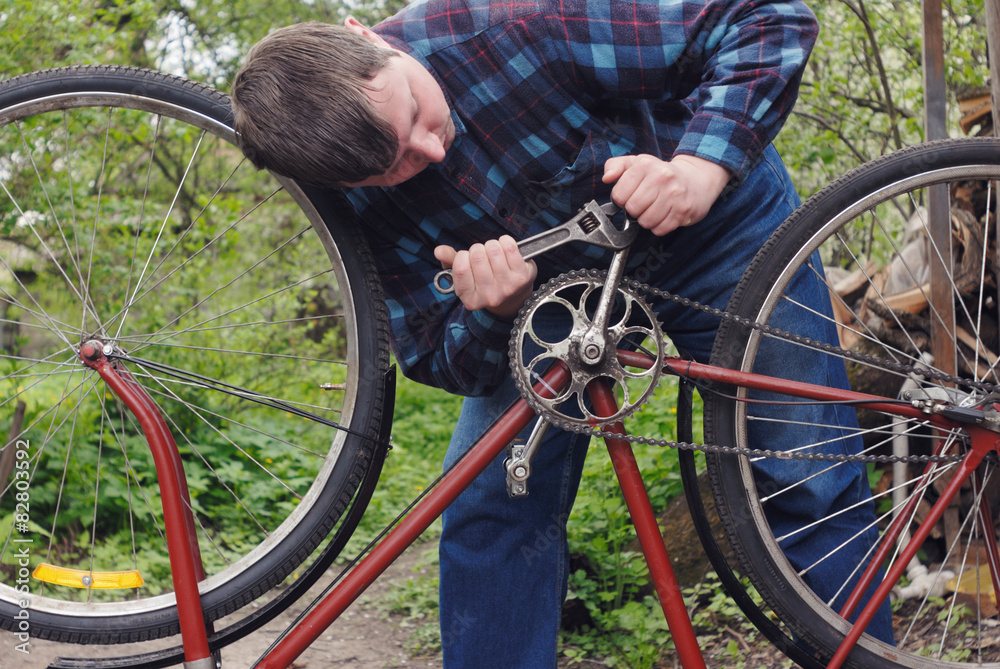 man repairing a bicycle-2 man repairing a bicycle-2