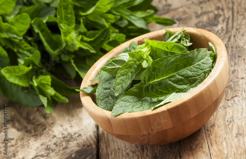 Fresh mint on an old wooden table, selective focus