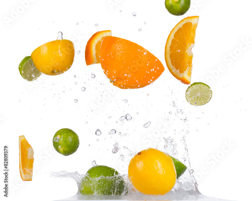 Fototapeta Naklejka Na Ścianę i Meble -  Citrus fruit in water splashes on black background