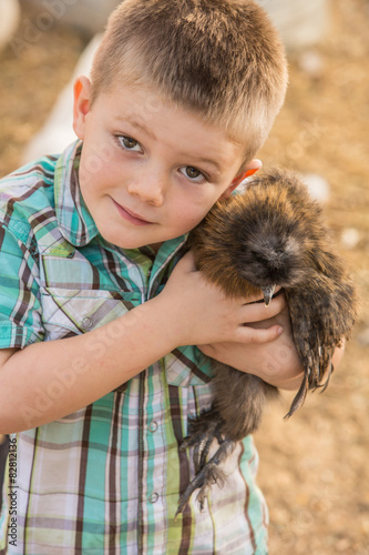 Boy Hugging Pet Chicken