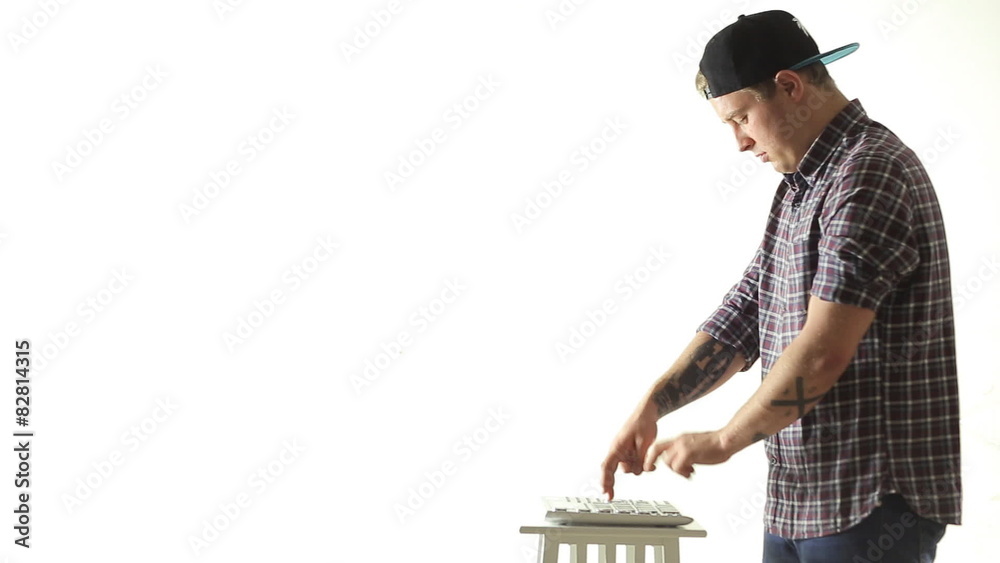 Trendy guy skillfully performs music on Pad Midi Controller Trendy guy skillfully performs music on Pad Midi Controller