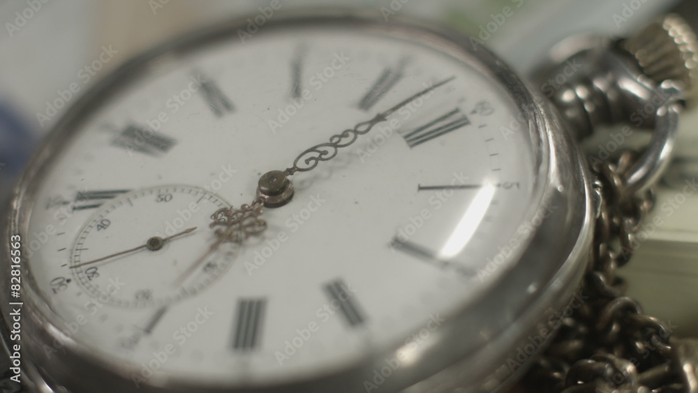 Pocket watch dial closeup, hands moving. Time flying by
Pocket watch dial closeup, hands moving. Time flying by