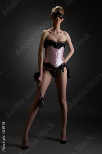 Domineering woman in erotic lingerie with lash © Wisky