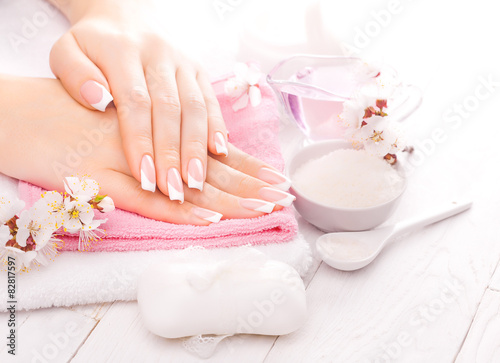 french manicure with essential oils  apricot flowers. spa