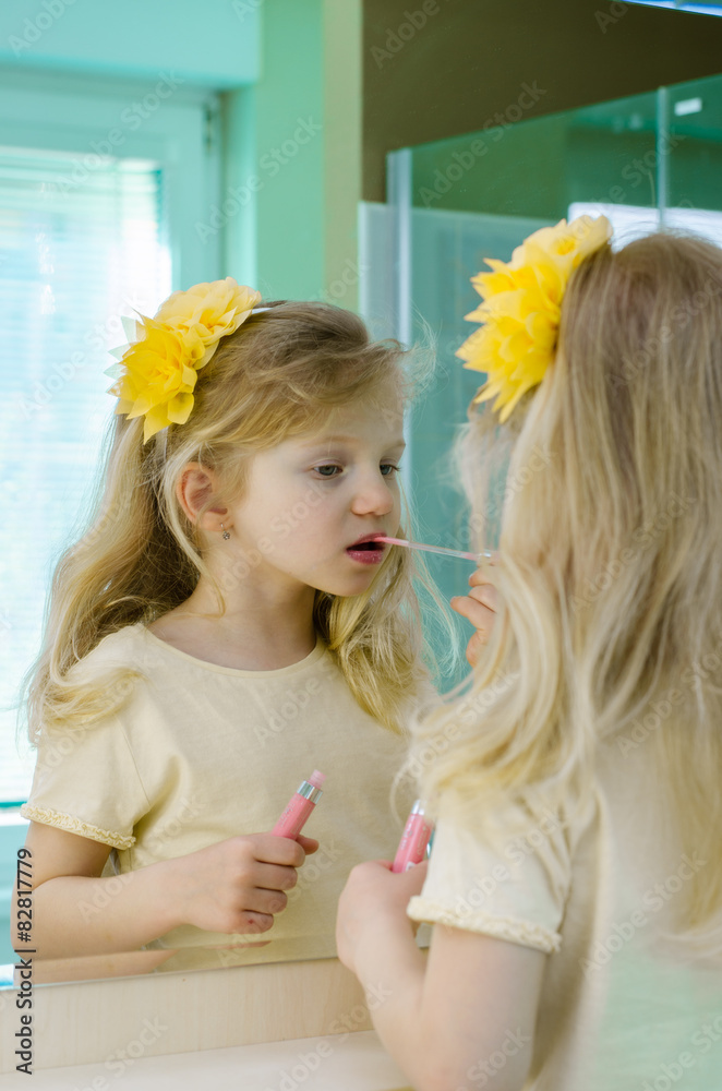 Fototapeta premium blond girl painting her lips