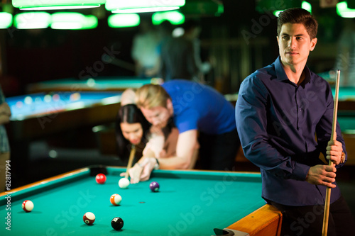 Young people playing pool