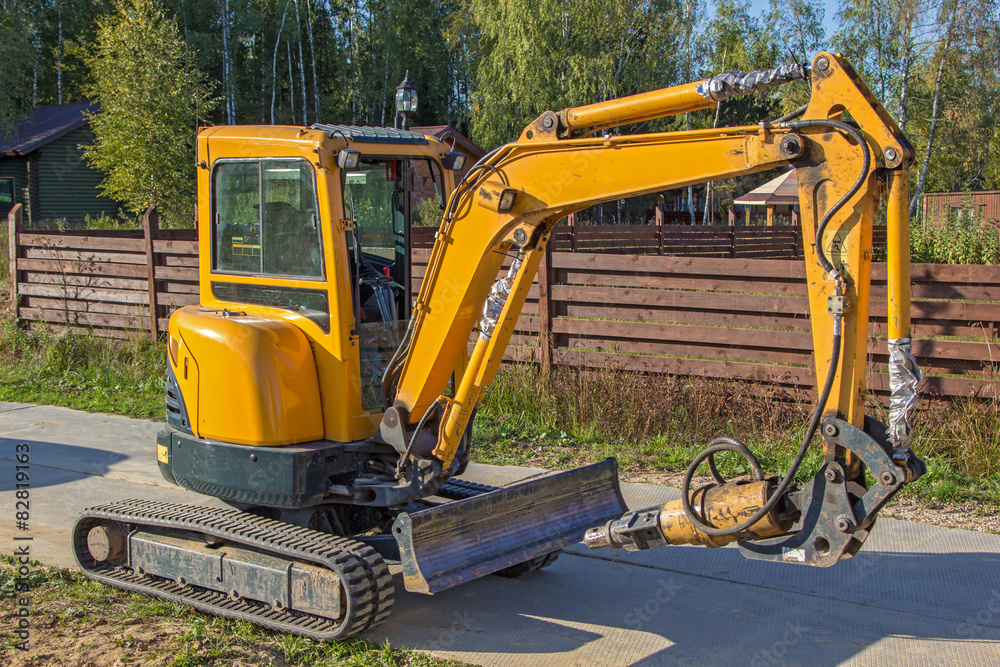small yellow crawler excavator for screwing piles