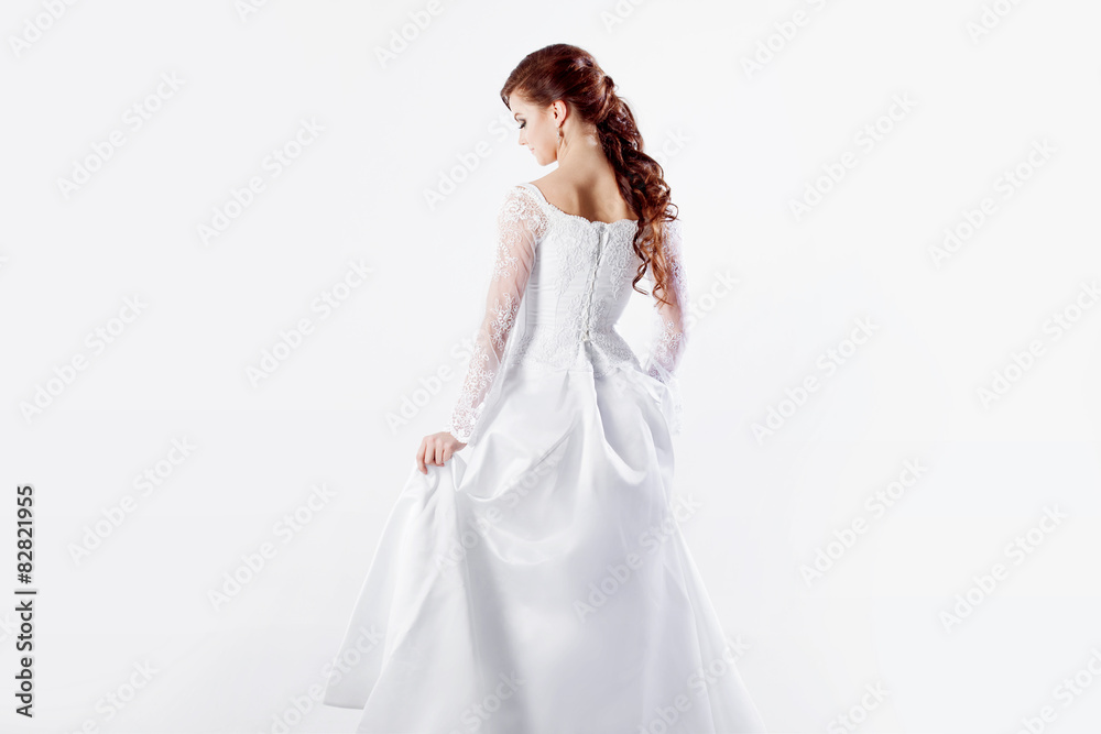 Beautiful bride in wedding dress, back, white background Beautiful bride in wedding dress, back, white background