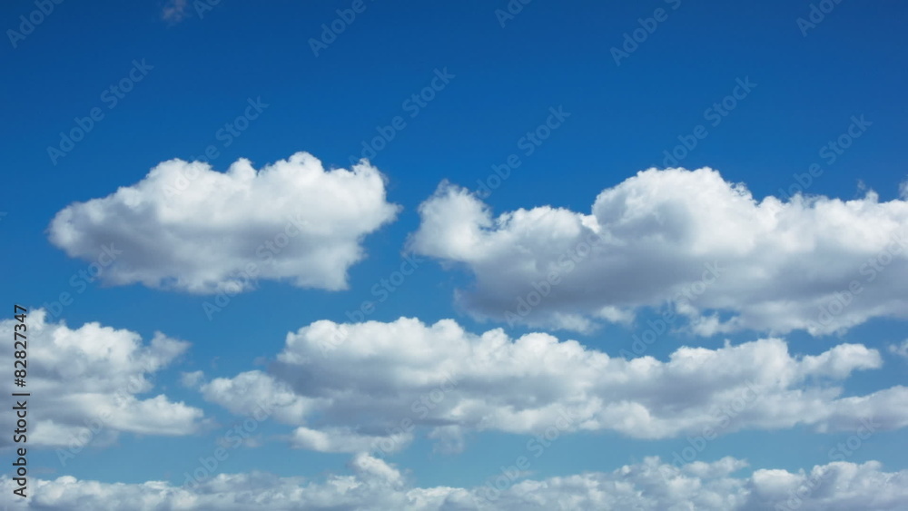 White puffy clouds timelapse on a blue sky background White puffy clouds timelapse on a blue sky background