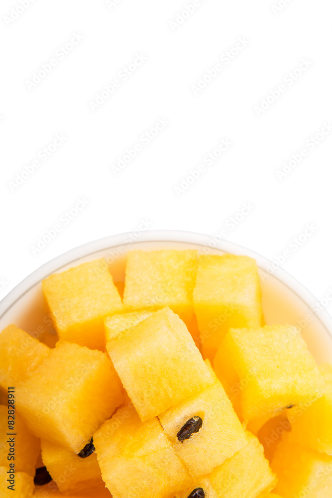 Bite size yellow watermelon in a white bowl Bite size yellow watermelon in a white bowl