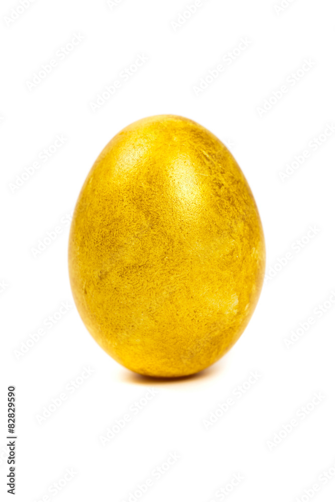 Golden egg isolated on white background. Macro. Selective focus. Golden egg isolated on white background. Macro. Selective focus.