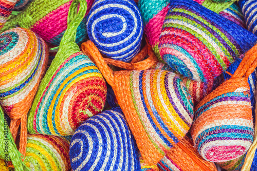 Close up stack of colorful handmade coin bag in market