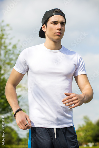 Young man running and jogging on road in country © theartofphoto