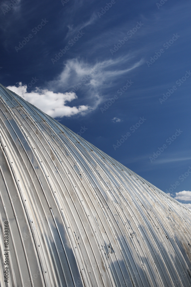 Naklejka premium metal hangar roof against the blue sky