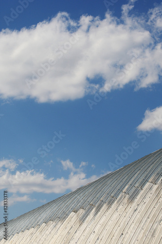 metal hangar roof against a blue sky