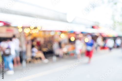 Blurred background : people shopping at market fair in sunny day © weedezign