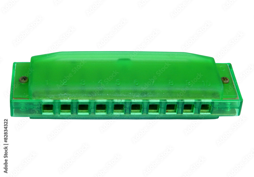 green harmonica, isolated on white background