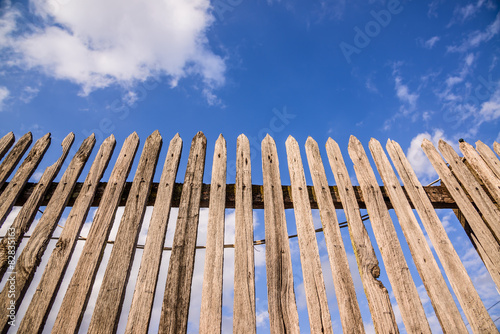 Old wooden fence on a blue sky