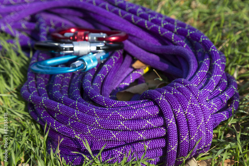 Purple climbing rope on green grass photo