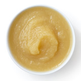 White ceramic dish of apple sauce on white.