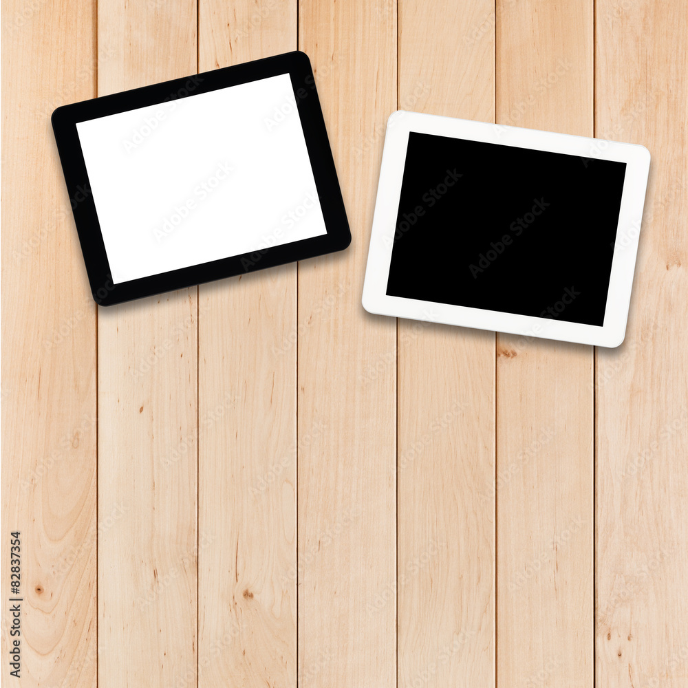 Two tablets PC on a wooden table Two tablets PC on a wooden table