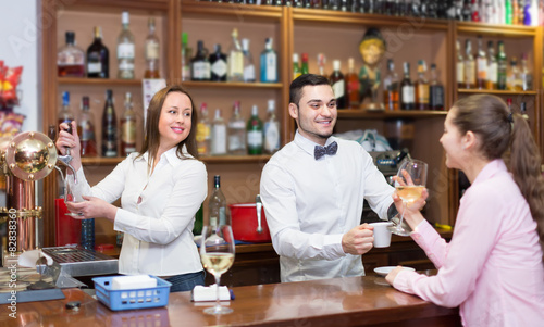 Girl flirting with barman at counter