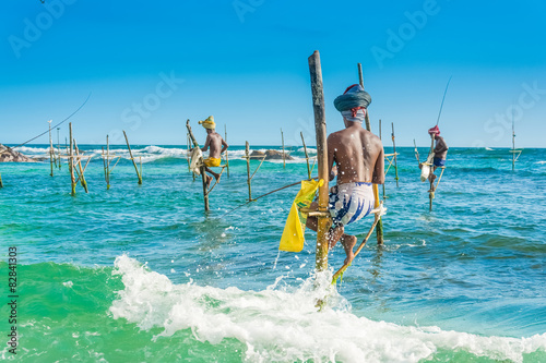 Sri Lankan unique tilt fishing style. Fishermen on the pole photo