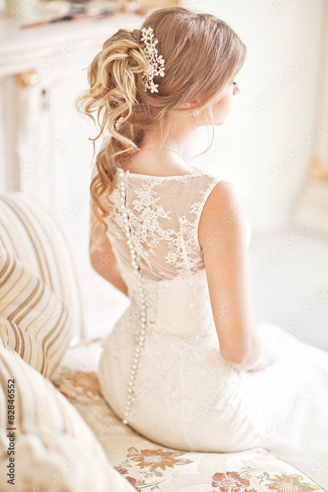 Fototapeta premium Young attractive bride in ivory tenderness wedding dress
