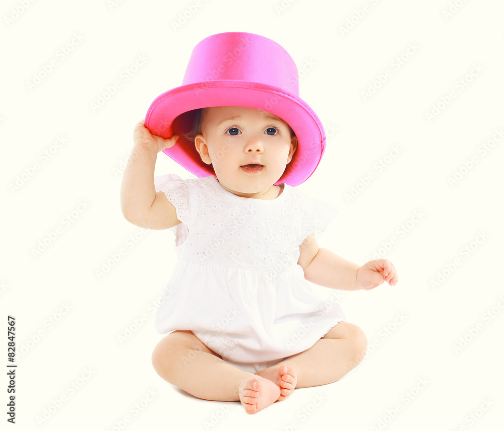 Portrait of sweet little baby sitting in pink hat Portrait of sweet little baby sitting in pink hat