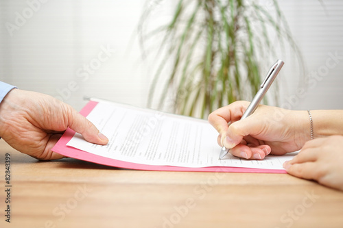 boss gives employee dismissal contract to sign