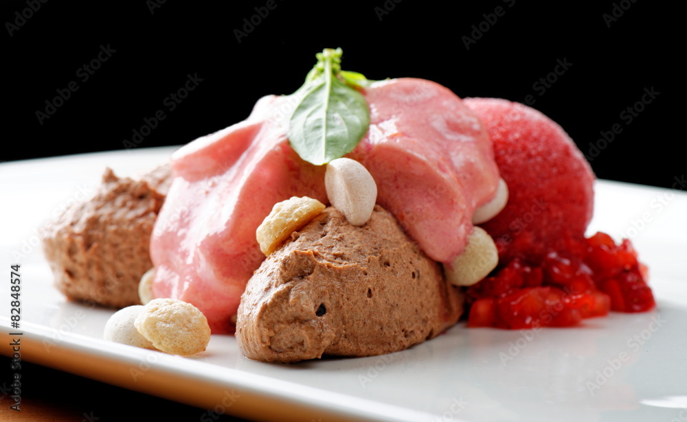 Fine dining dessert, chocolate mousse and strawberry ice cream 