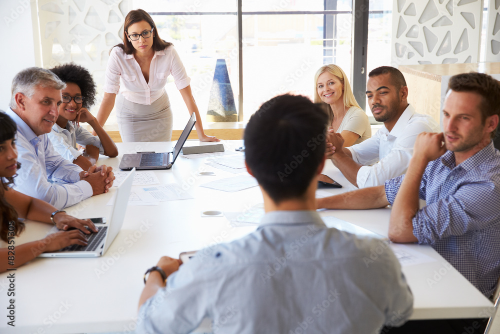 Businesswoman presenting to colleagues at a meeting Businesswoman presenting to colleagues at a meeting