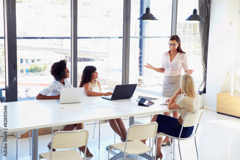 Businesswoman presenting to colleagues at a meeting Businesswoman presenting to colleagues at a meeting
